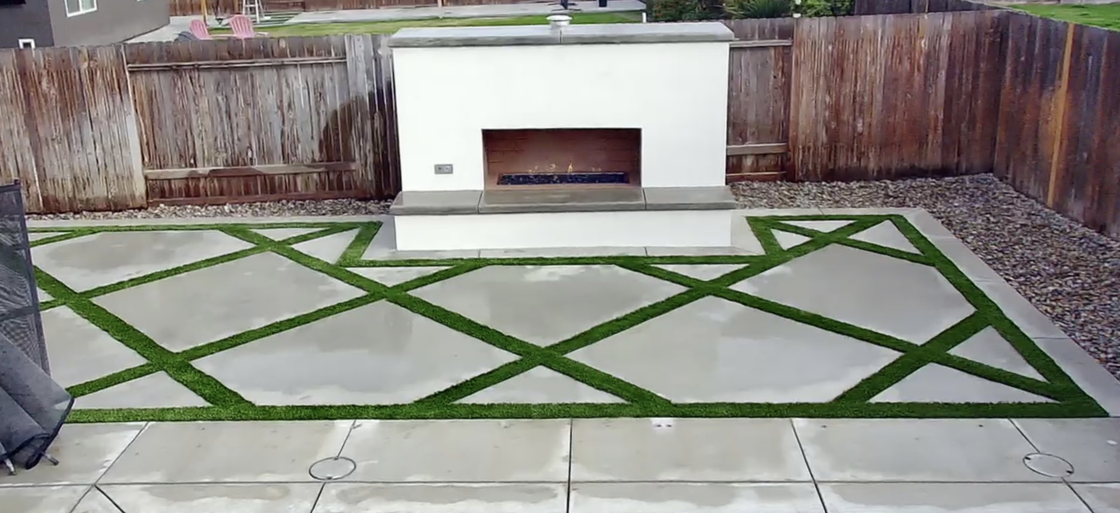 Modern patio with geometric pavers and custom fire feature