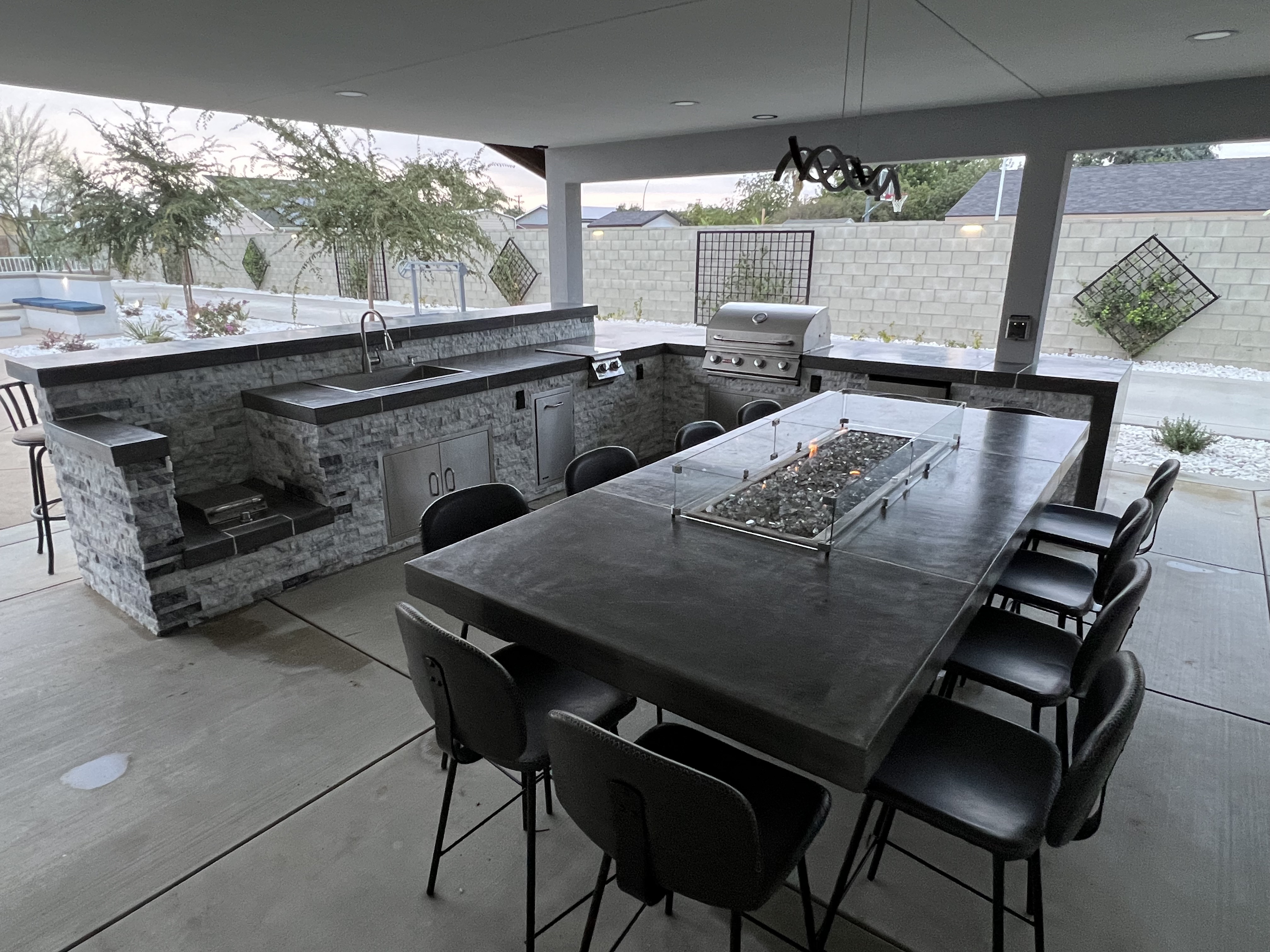 Premium outdoor kitchen with fire pit table and entertainment setup