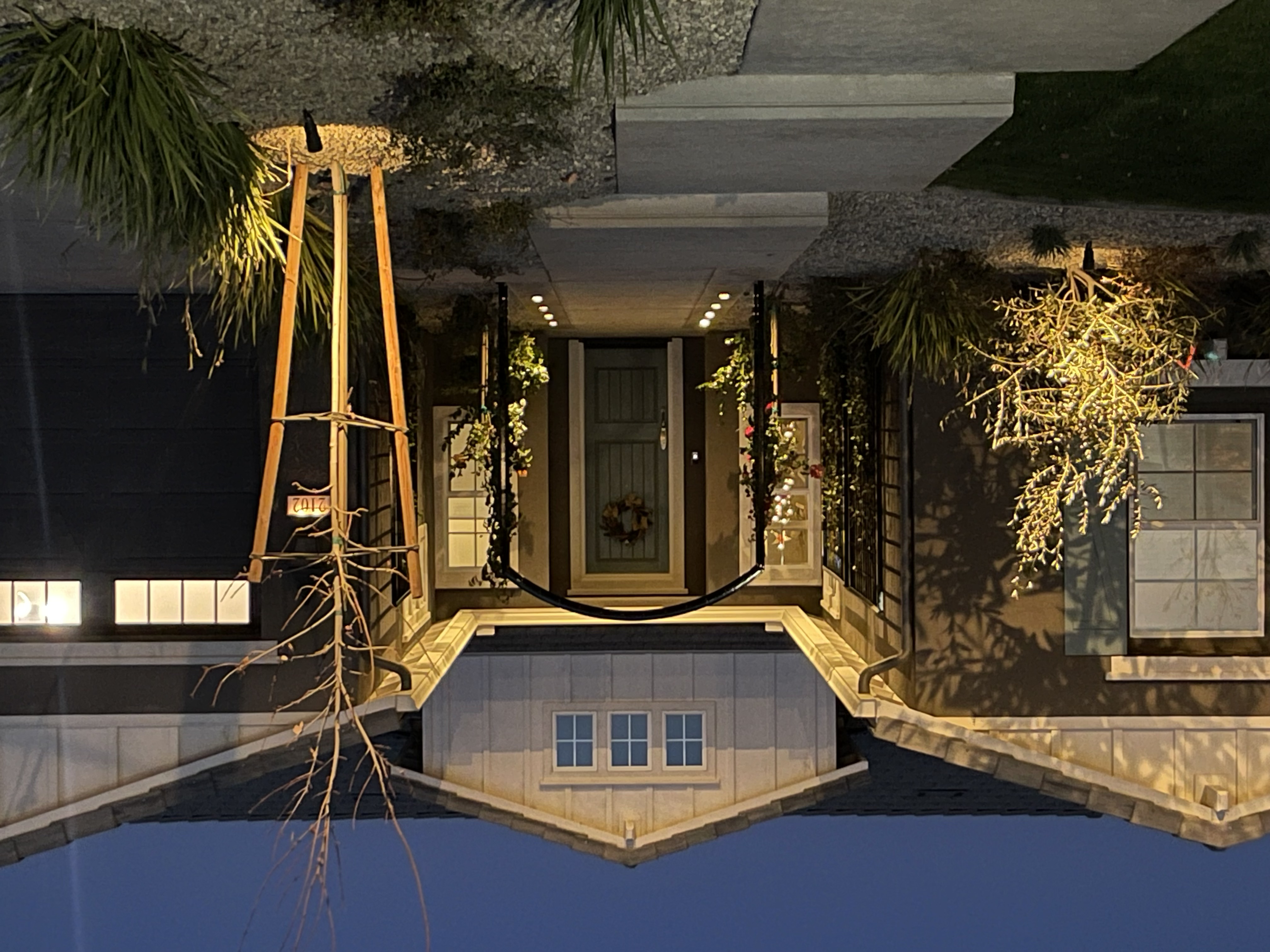 Evening pool reflection with covered patio and elegant lighting