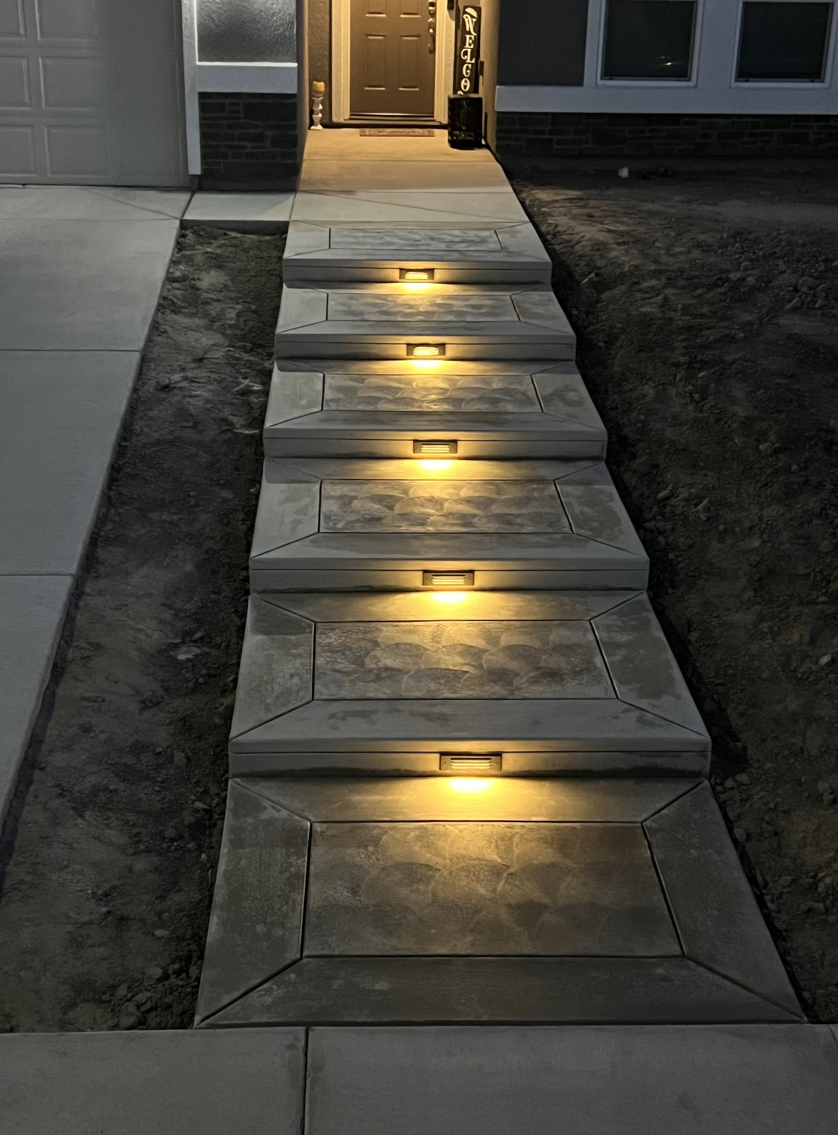 Illuminated walkway with LED step lighting at night