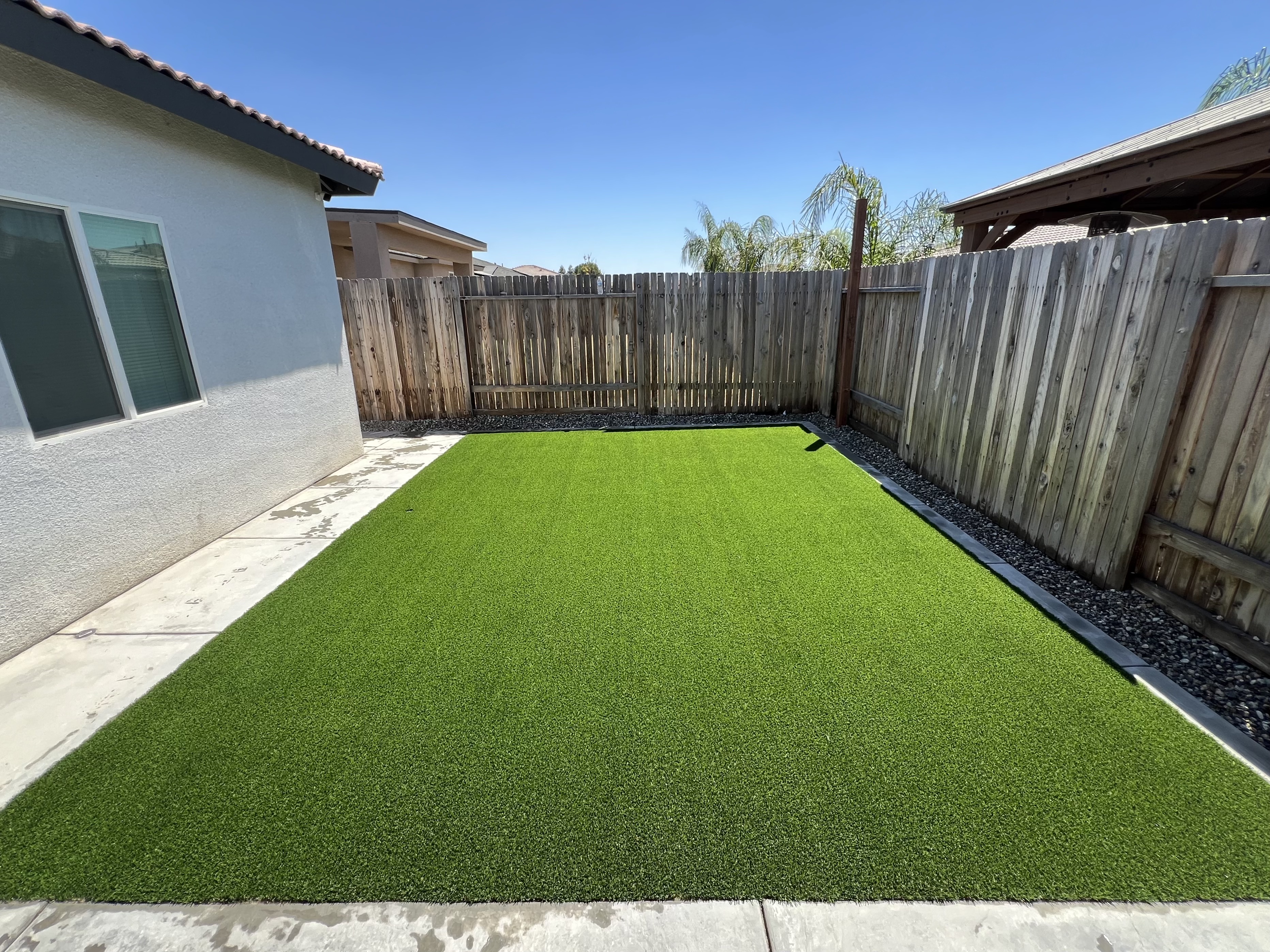 Pristine artificial turf backyard installation